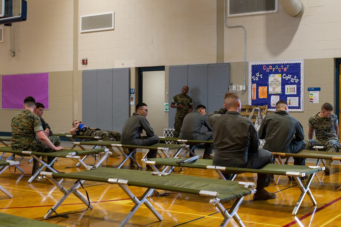 U.S. Marines role-play as members of the community seeking shelter during HURREX inside the gymnasium at the Cherry Treehouse, Marine Corps Air Station (MCAS) Cherry Point, North Carolina, May 16, 2022. HURREX is a week-long hurricane preparedness exercise held across the installation that’s intended to increase MCAS Cherry Point’s readiness for the Atlantic hurricane season. (U.S. Marine Corps photo by Lance Cpl. Lauralle Walker)