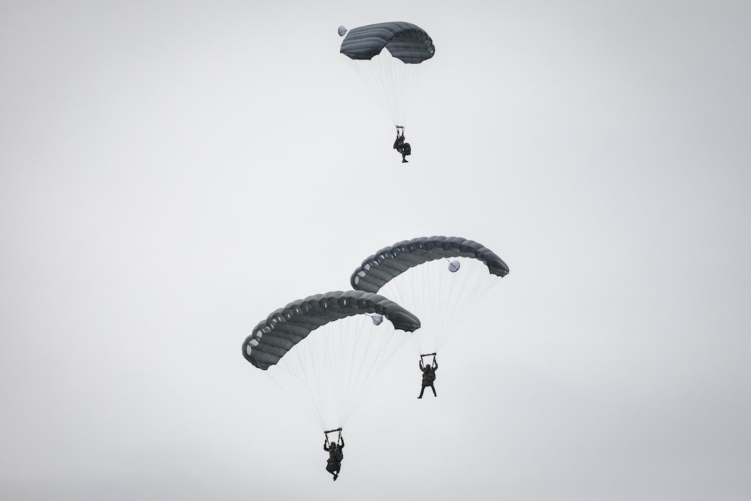 Green Berets parachute to the ground.