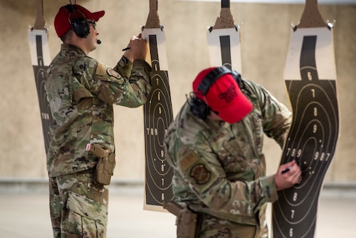 88th Security Forces Squadron combat arms instructors scores targets during the M18 9mm pistol Excellence in Competition shooting event