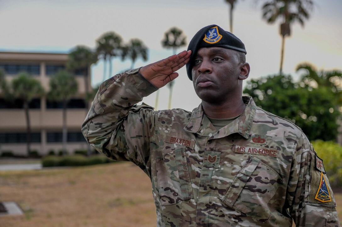 U.S. Air Force Tech. Sgt. Koeal Braxton, 45th Security Forces Squadron flight sergeant, salutes the American flag May 20, 2022, at Patrick Space Force Base, Fla. Airmen at the fallen hero ceremony salute the flag to recognize and honor all lives that were lost in the line of service for the United States. (U.S. Space Force photo by Airman 1st Class Samuel Becker)