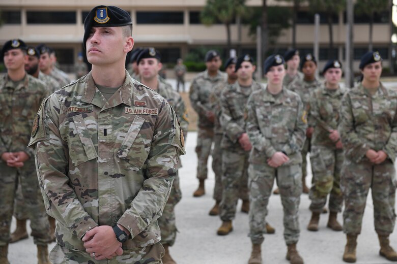 U.S. Air Force 45th Security Forces Squadron stand at ease during the fallen hero ceremony May 20, 2022, at Patrick Space Force Base, Fla. The fallen hero ceremony represents and honors all of the fallen heroes who have lost their lives in the line of action. (U.S. Air Force photo by Airman 1st Class Samuel Becker)