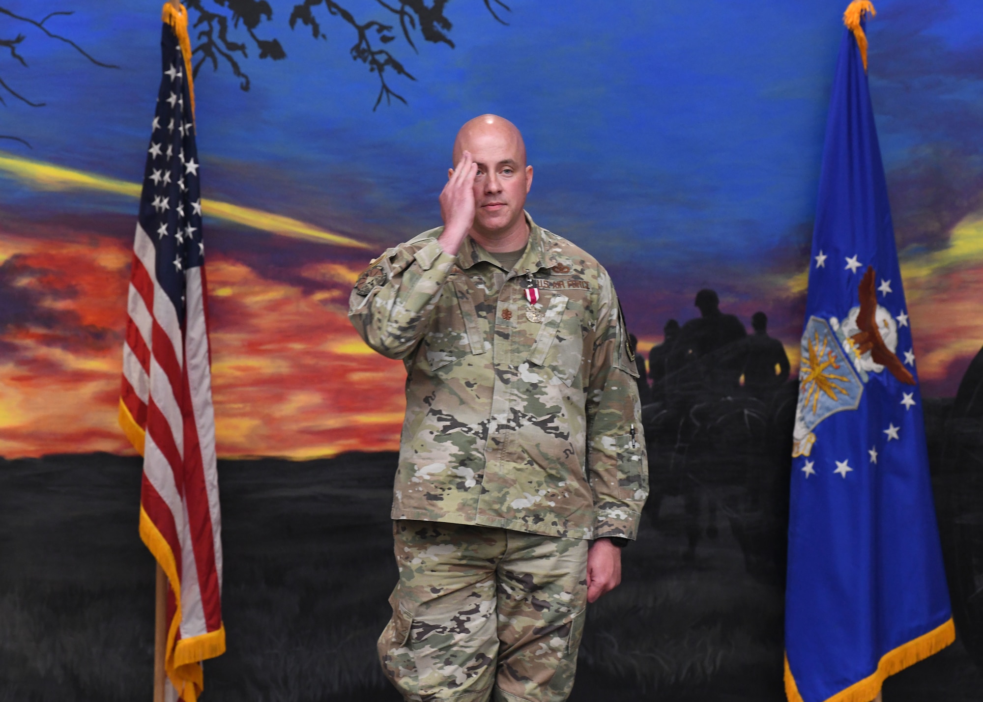 Maj. Dexter Binion, outgoing commander of the 90th Ground Combat Training Squadron, renders his final salute to members of 90 GCTS during a change of command ceremony May 26, 2021 in the Regional Training Institute building at Camp Guernsey, Wyoming. The change of command ceremony signifies the transition of command from Binion, to Maj. Robert Hudspeth, the incoming commander of 90 GCTS. (U.S. Air Force photo by Airman 1st Class Darius Frazier.)
