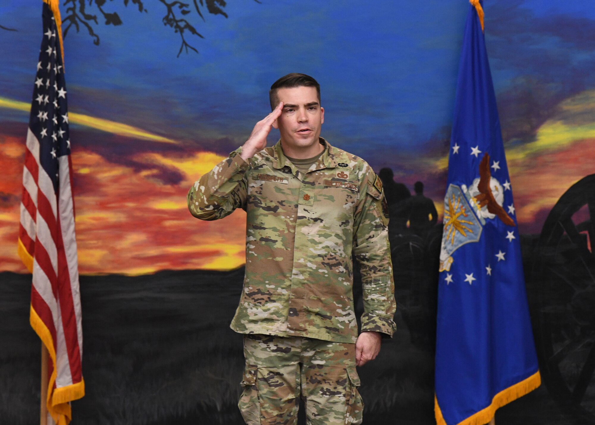 Maj. Robert Hudspeth, the incoming commander of the 90th Ground Combat Training Squadron, renders his first salute to members of the 90 GCTS during a change of command ceremony May 26, 2021 in the Regional 
Training Institute building at Camp Guernsey, Wyoming. The change of command ceremony signifies the transition of command from Maj. Dexter Binion, the outgoing commander of the 90 GCTS, to Hudspeth. (U.S. Air Force photo by Airman 1st Class Darius Frazier.)