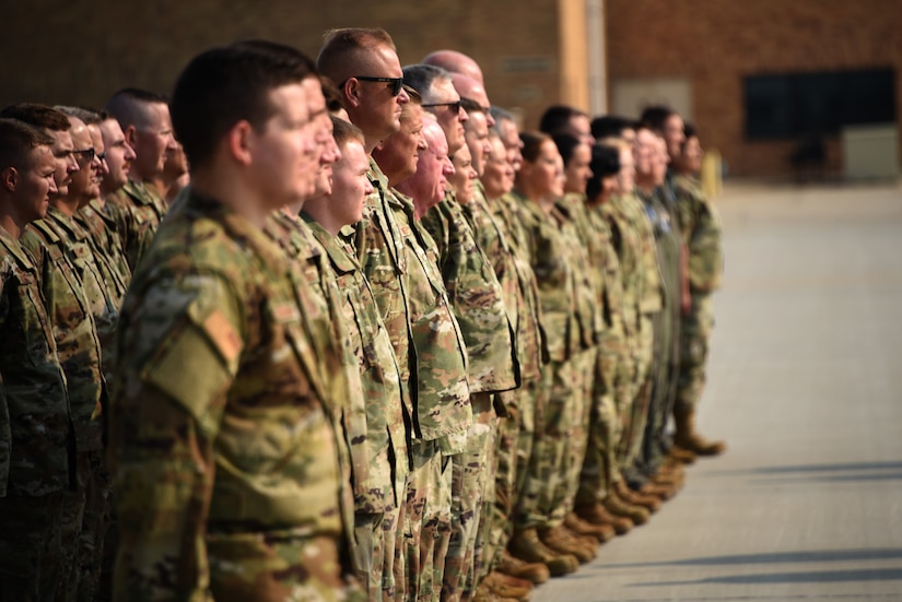 Multiple service members stand in a formation.