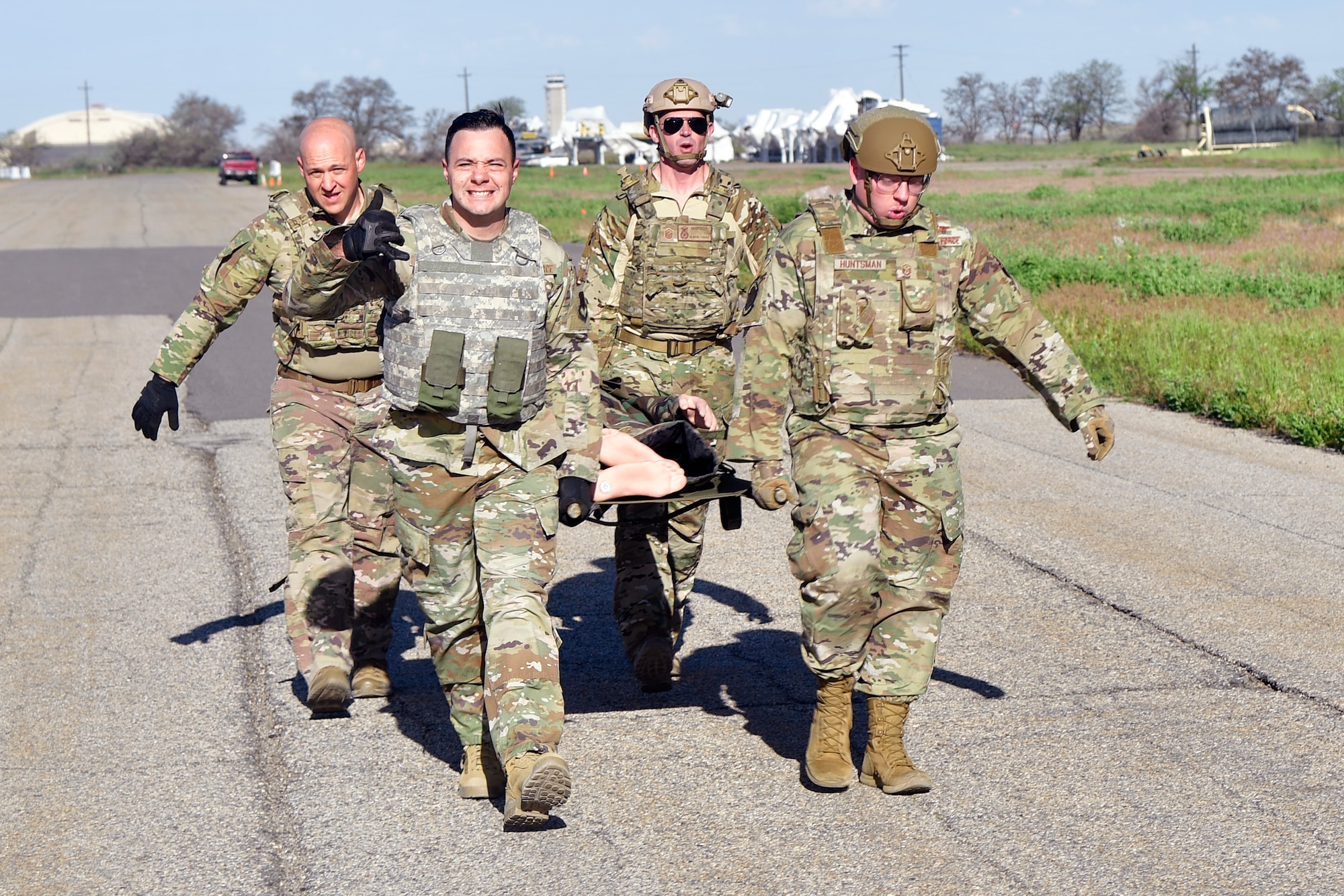 Airmen carrying a stretcher.