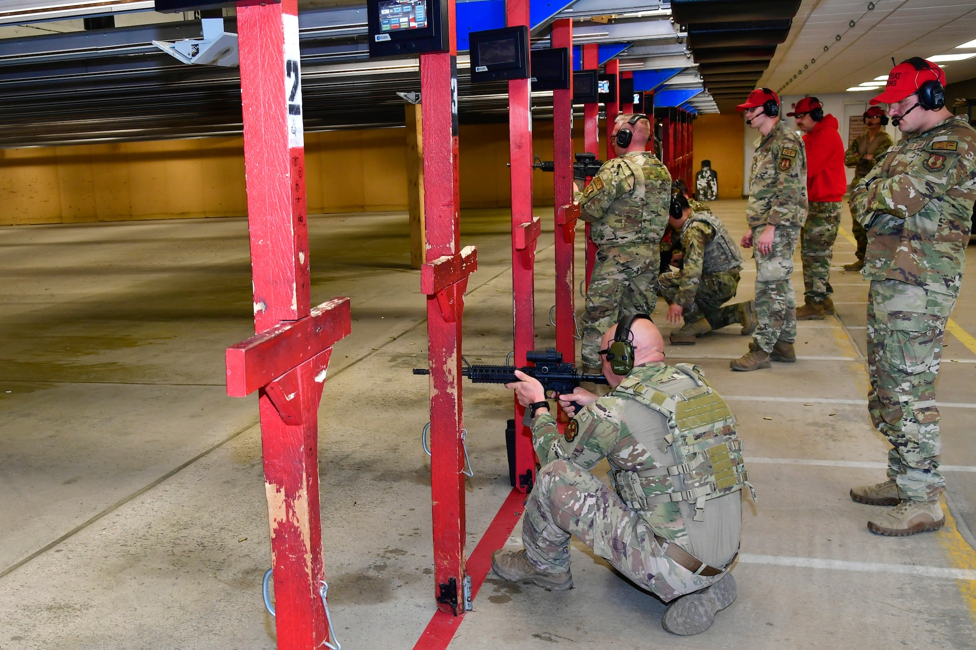 Master Sgt. Timothy Bublitz fires at targets in the crouch position.
