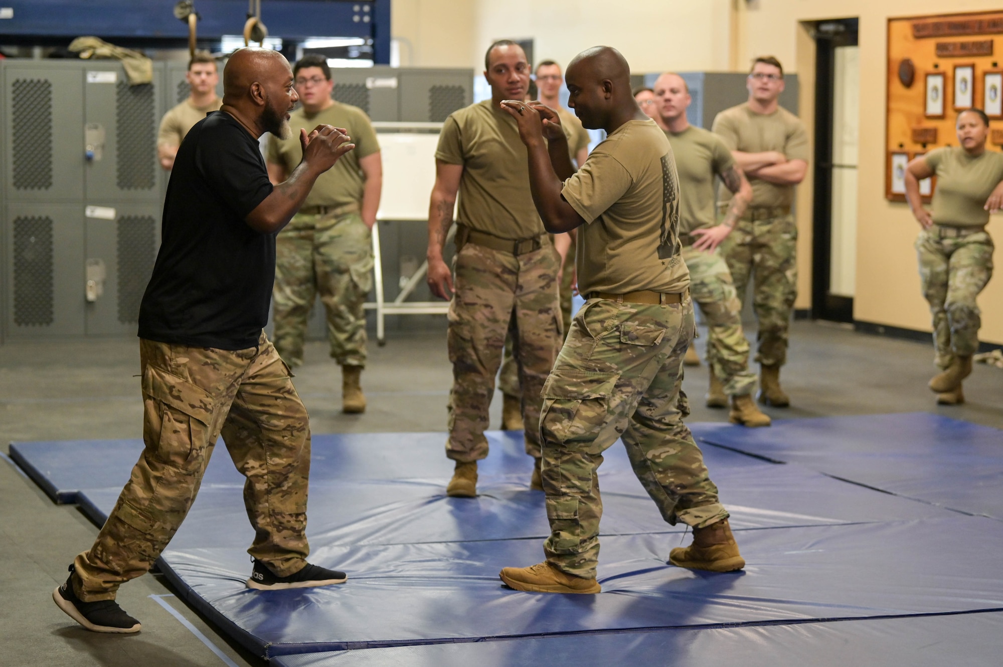 Bobby Cumby, retired security force defender and Office of Special Investigations agent, and Krav Maga instructor, left, holds a fighting stance with U.S. Air Force Staff Sgt. Sheldon Clarke, 23rd Security Force Squadron S3O-B2 “Thunder Cats” flight sergeant, right, during the first iteration of Krav Maga training, April 13, 2022, at Moody Air Force Base, Georgia. Krav Maga translates to “close combat,” and the guiding principle is self-protection while neutralizing the threat at hand. (U.S. Air Force photo by Senior Airman Rebeckah Medeiros)