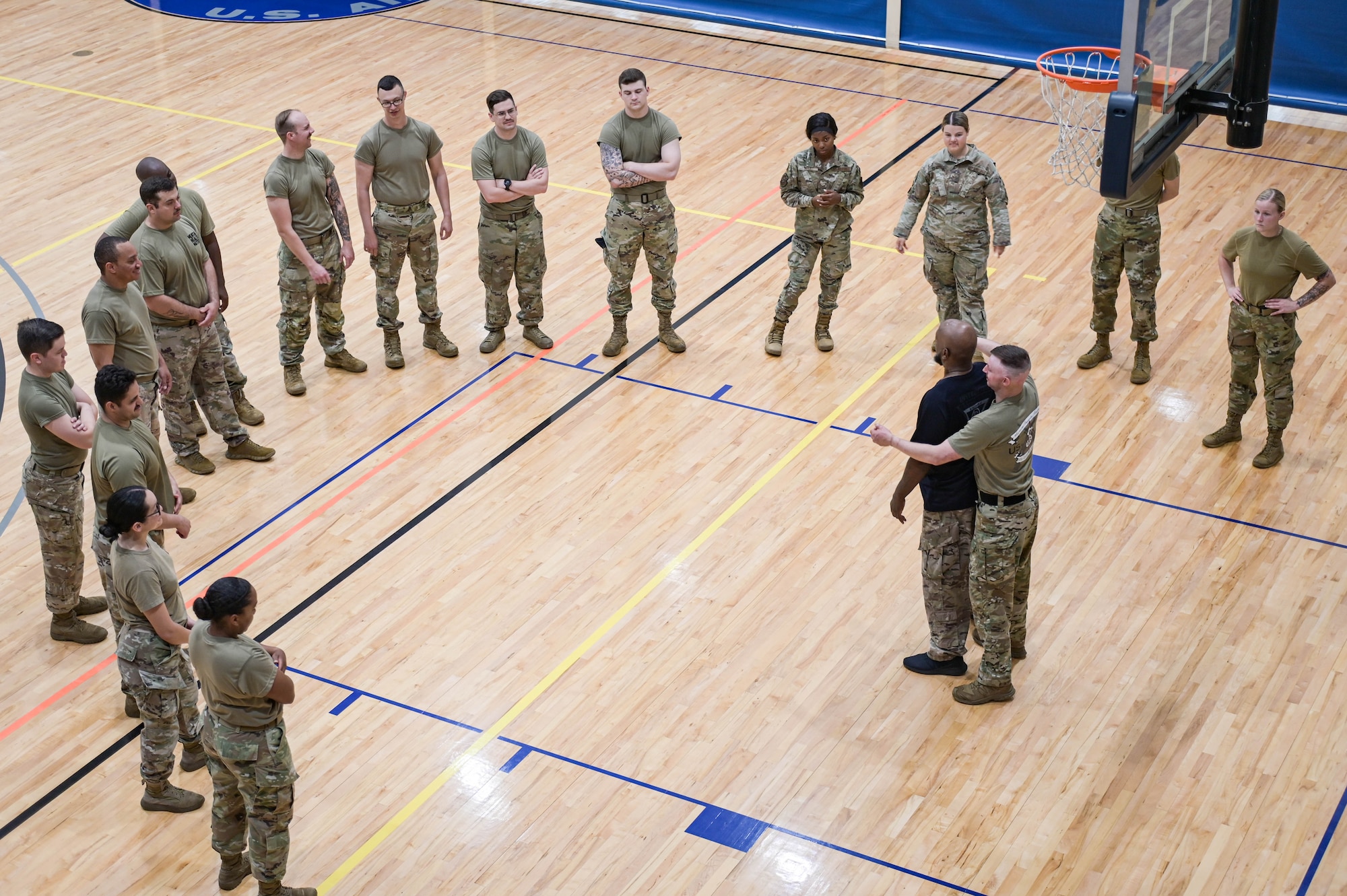 Airmen from the 23rd Security Forces Squadron circle around Bobby Cumby, a retired SFS defender and Office of Special Investigations agent, as he demonstrates how to escape a hold during the second iteration of Krav Maga training at Moody Air Force Base, Georgia, May 25, 2022. Krav Maga translates to “close combat,” and the guiding principle is self-protection while neutralizing the threat at hand. (U.S. Air Force photo by Senior Airman Rebeckah Medeiros)