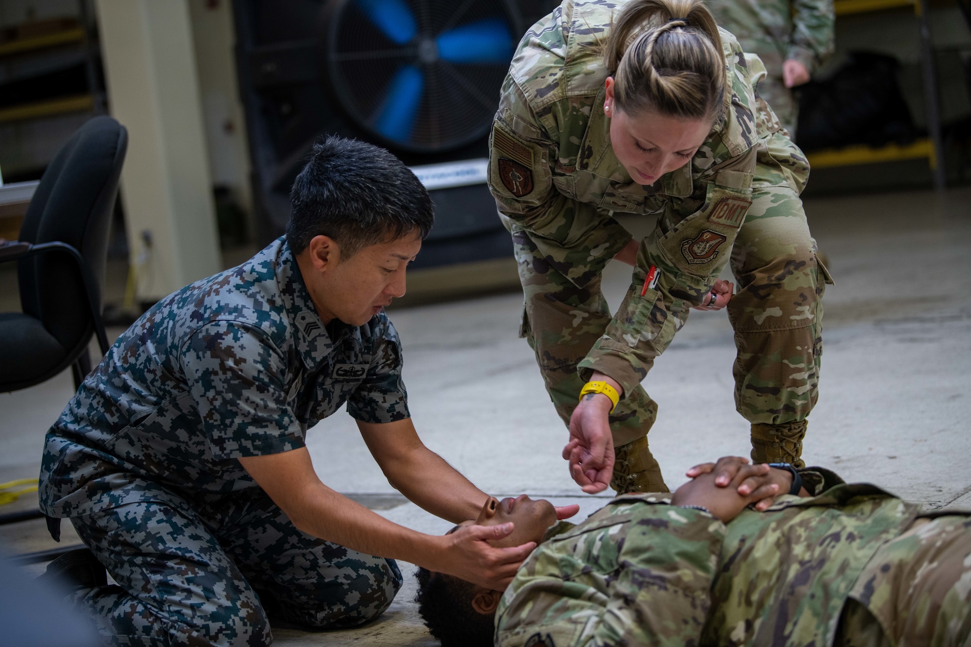 Airmen and a JASDF service member practice patient care