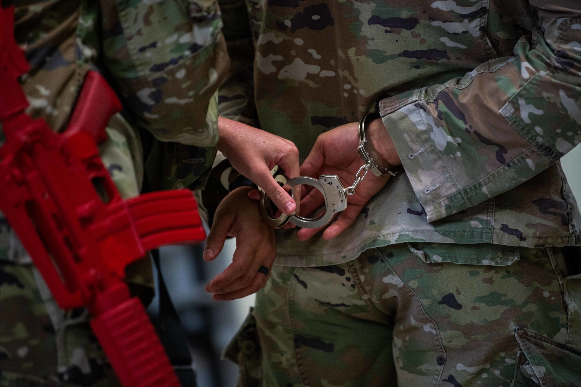 Airmen practice handcuffing procedures.