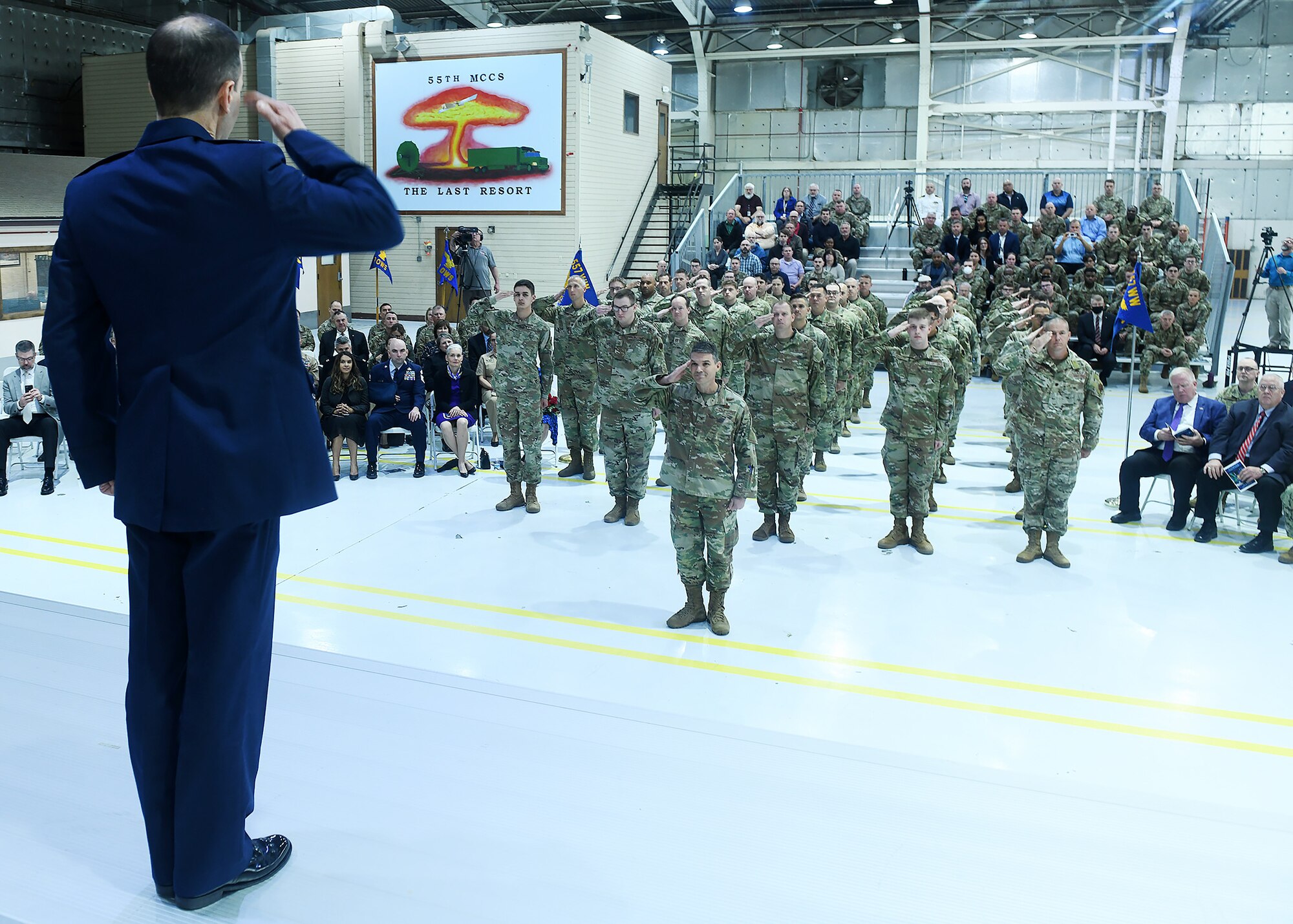 Col. Bradley Stebbins salutes the formation of 557th Weather Wing Airmen for the first time as the new 557th Weather Wing commander during a ceremony on May 24, 2022 in hangar six on Offutt AFB.
