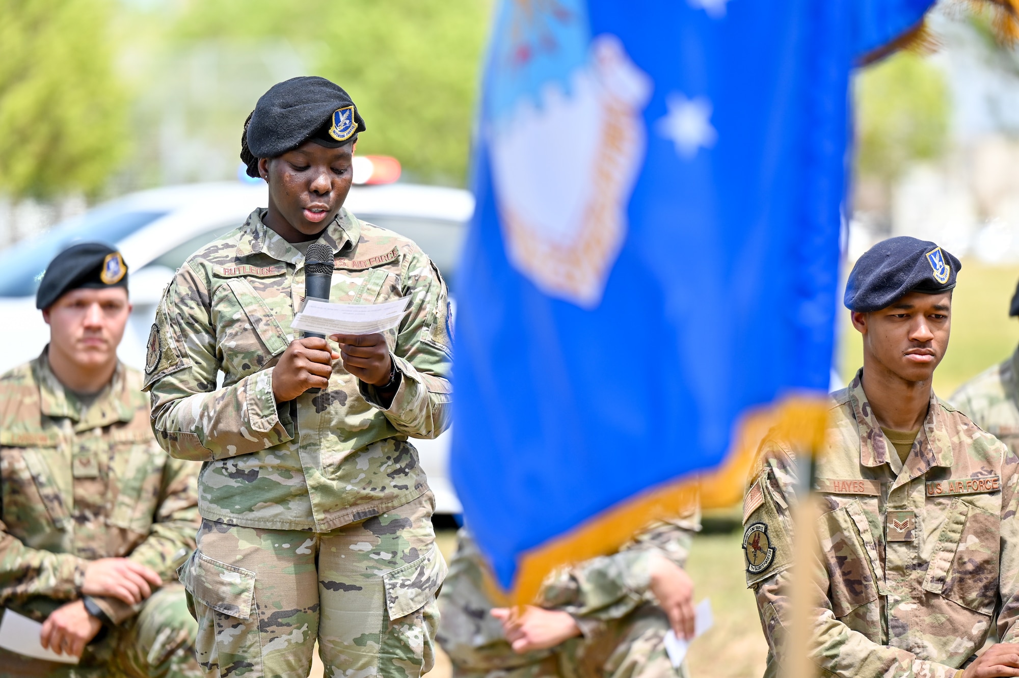 Senior Airman Travionna Rutledge speaks into a microphone.