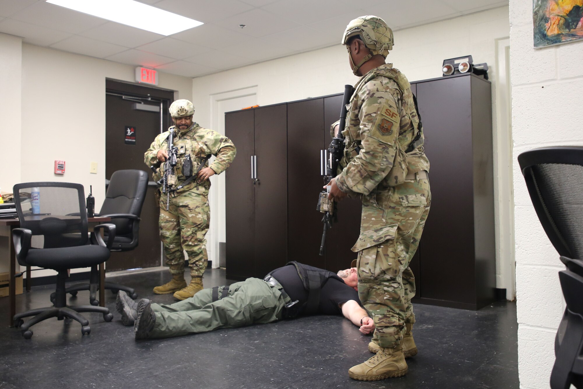Staff Sgt. Jerome Foye Jr., 7th Security Forces Squadron Police Services NCO in charge, and Tech. Sgt. Axel Sterrett, 7th SFS flight sergeant, simulate taking down an active shooter during an exercise at Dyess Air Force Base, Texas, May 24, 2022.
