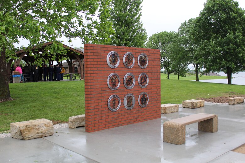 Wall displaying the emblems of the Armed Services, and the POW-MIA and Purple Heart emblems