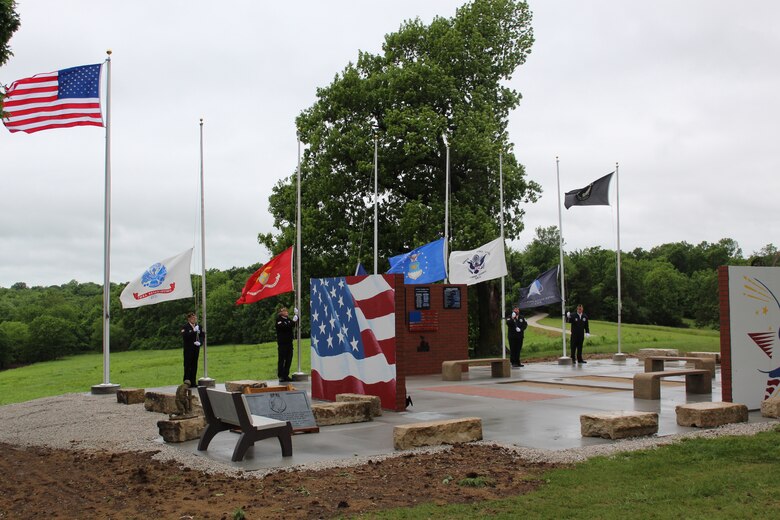 American Legion Post 230 Color Guard raises flags at the Veterans Memorial at Stockton Lake during the dedication ceremony.