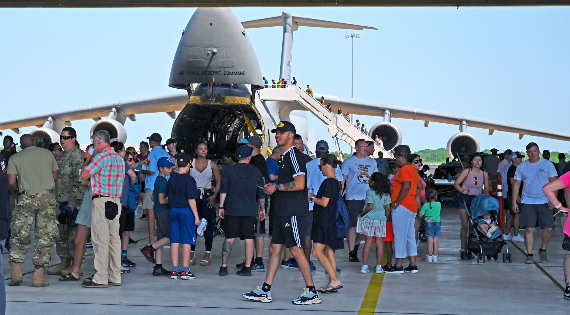 Reserve Citizen Airmen and their families participate in the 2022 433rd Airlift Wing Family Day May 15, 2022, at Joint Base San Antonio-Lackland, Texas. A C-5M Super Galaxy aircraft was opened for public display during the event. (U.S. Air Force photo by Master Sgt. Samantha Mathison)