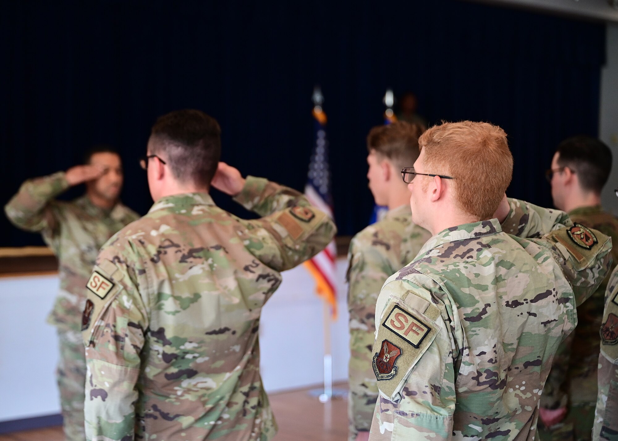 airmen saluting during taps