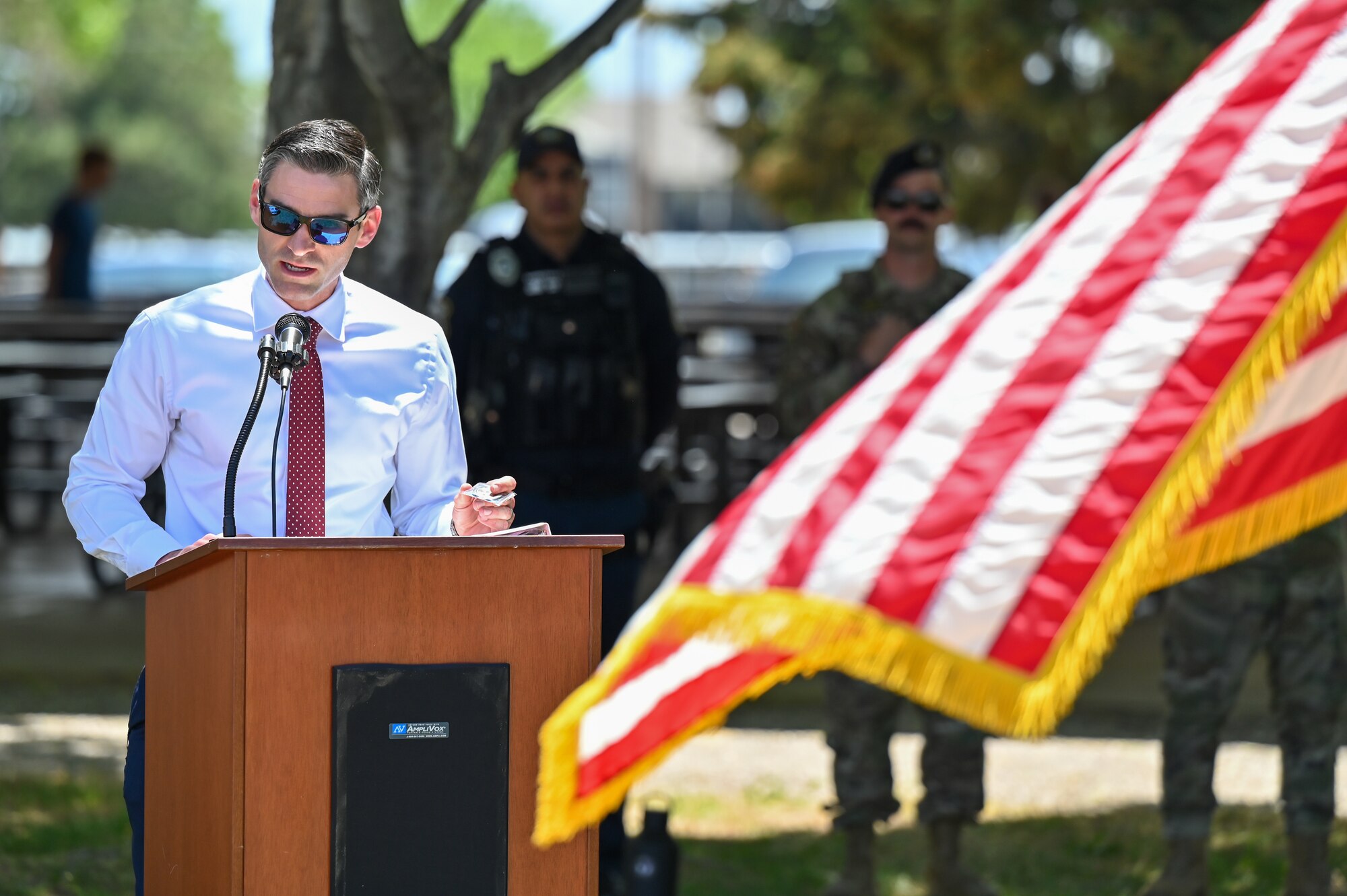 Major Bradley Byington speaks from behind a podium.