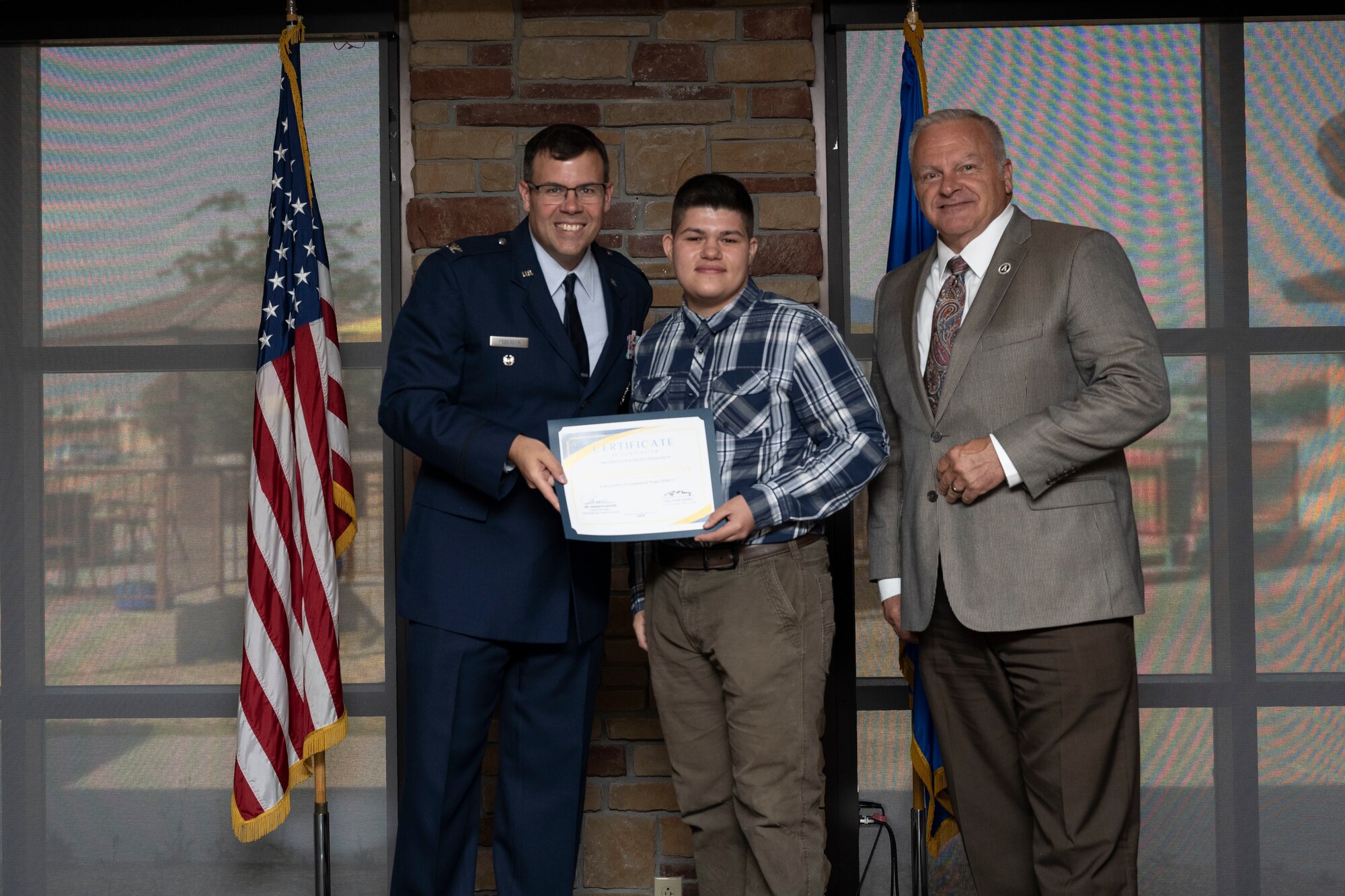 Devin Stevenson-Gutierrez, Project SEARCH intern, receives graduation certificate, May 24, 2022, on Holloman Air Force Base, New Mexico.