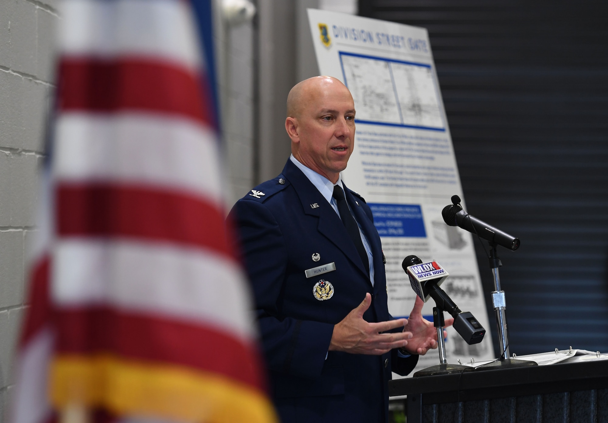 U.S. Air Force Col. William Hunter, 81st Training Wing commander, delivers remarks during the Division Street Gate Ribbon Cutting Ceremony inside the Commercial Vehicle Inspection Building at Keesler Air Force Base, Mississippi, May 26, 2022. After approximately two years of construction, Keesler's new main gate marks the completion of a multi-sourced and multi-funded project which will enhance force protection and anti-terrorism measures. Keesler partnered with the city of Biloxi, along with state and federal planners, to align the primary entrance at Division Street. (U.S. Air Force photo by Kemberly Groue)