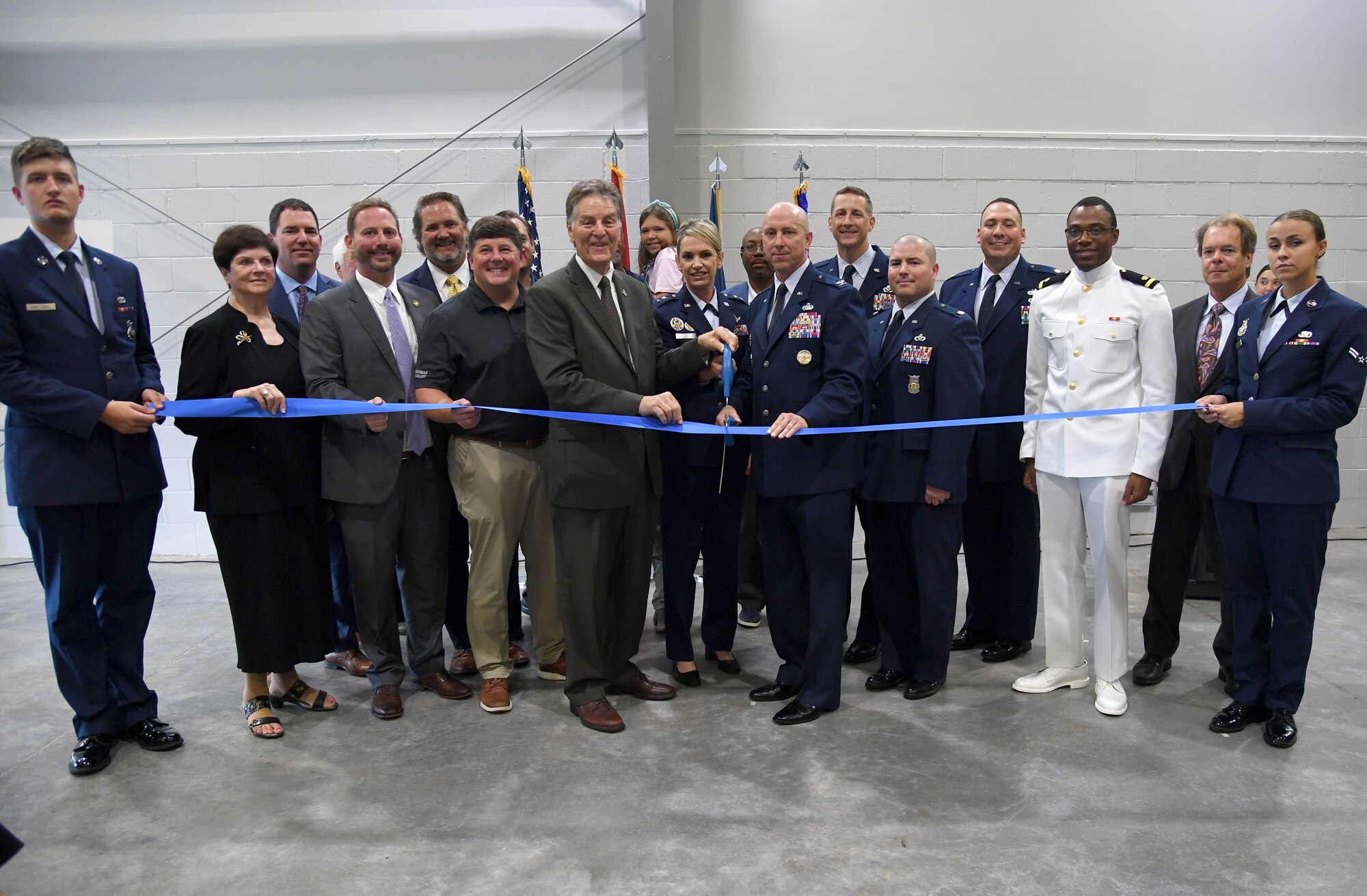 Keesler leadership and Mississippi state and local government officials, pose for a photo during the Division Street Gate Ribbon Cutting Ceremony inside the Commercial Vehicle Inspection Building at Keesler Air Force Base, Mississippi, May 26, 2022. After approximately two years of construction, Keesler's new main gate marks the completion of a multi-sourced and multi-funded project which will enhance force protection and anti-terrorism measures. Keesler partnered with the city of Biloxi, along with state and federal planners, to align the primary entrance at Division Street. (U.S. Air Force photo by Kemberly Groue)