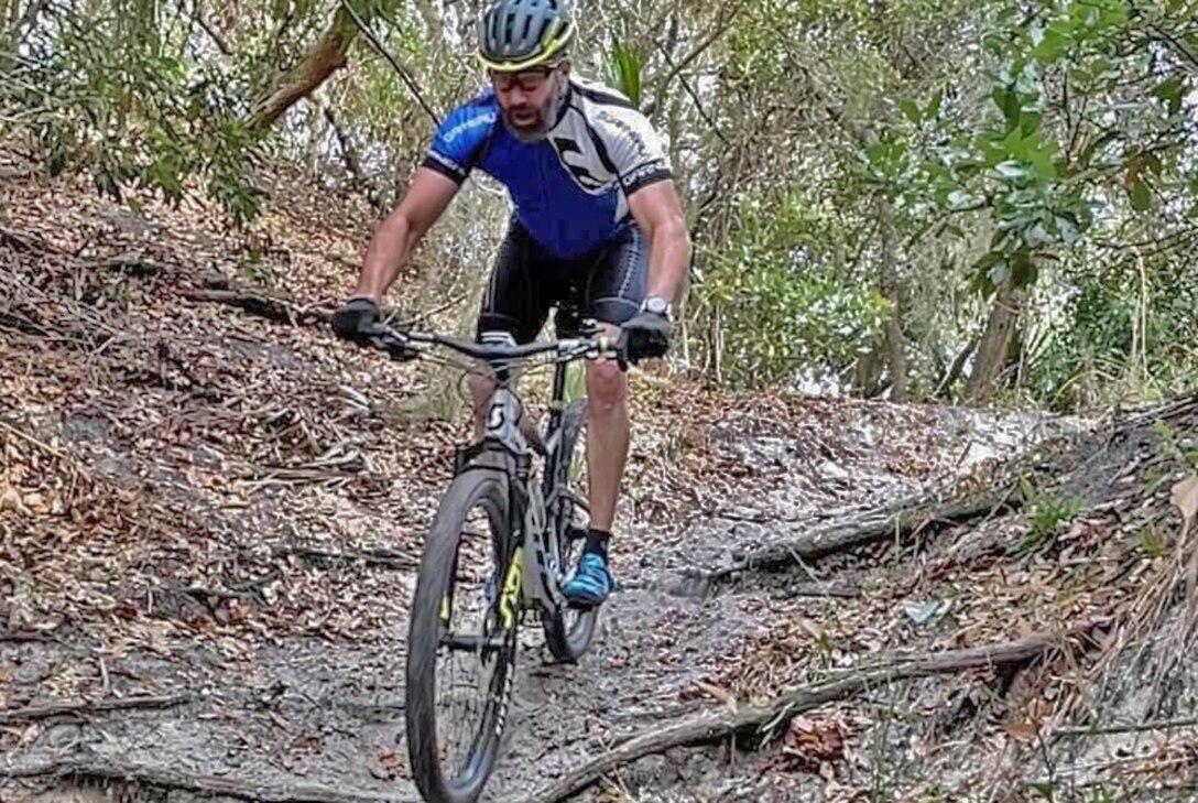 A man rides a mountain bike on a trail.