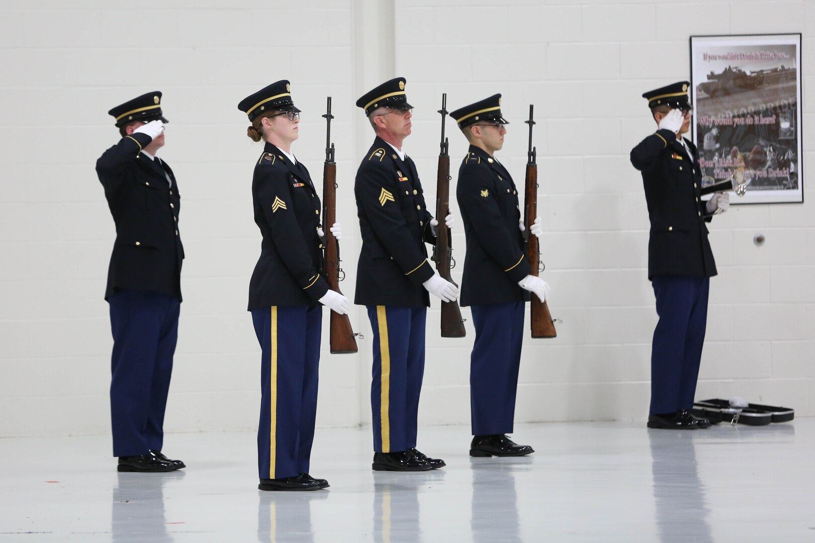 Group of dress uniformed Soldiers (two rendering hand salutes, three rendering rifle salutes)