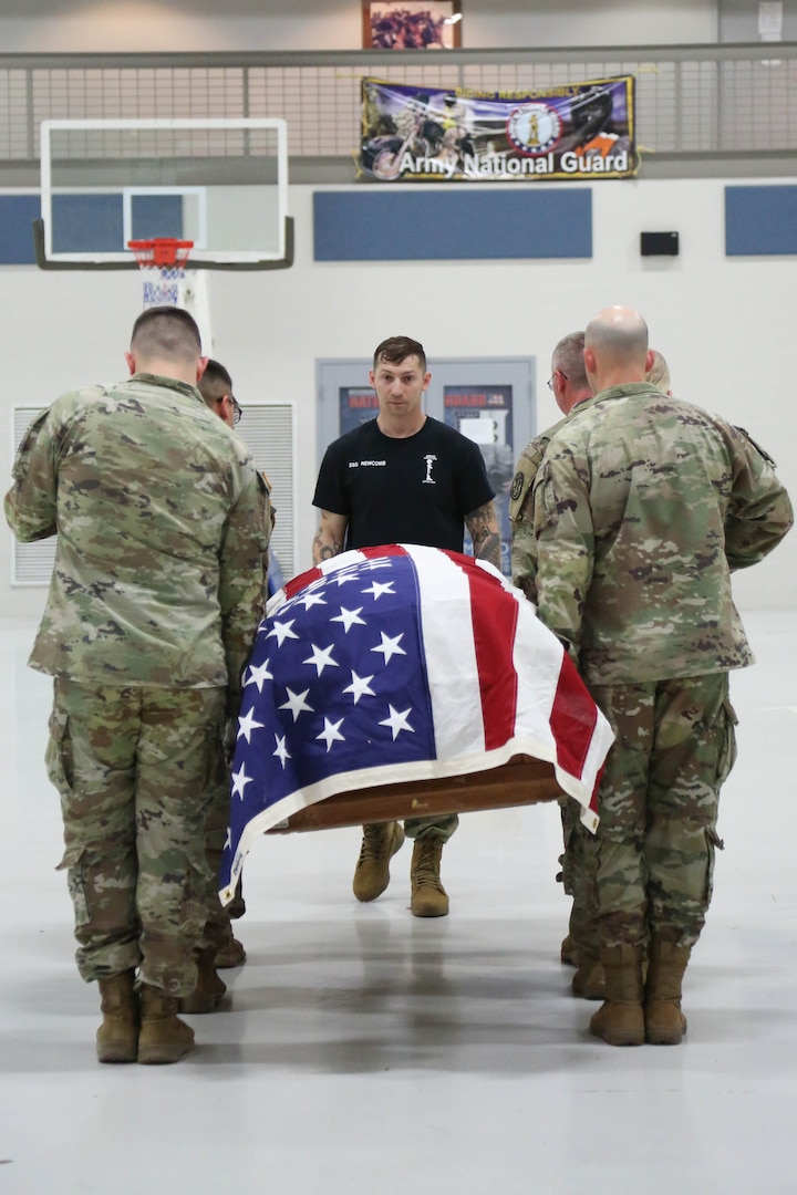 Group of Uniformed Pallbearers carry flag covered coffin