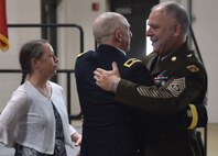 Command Sgt. Maj. Paul Edwards (right), command sergeant major for the Vermont Army National Guard, congratulates Brig. Gen. David Manfredi, the Vermont National Guard director of joint staff, and his wife, Kathy, after Manfredi's retirement ceremony May 26, 2022 at Camp Johnson, Vermont. Manfredi retired May 26 after more than 30 years of service, including assignments as commander of the 124th Regiment (Regional Training Institute) and commander of the 3-172nd Infantry (Mountain). He deployed to Afghanistan twice in support of Operation Enduring Freedom. (U.S. Army National Guard photo by 1st Lt. Nathan Rivard)