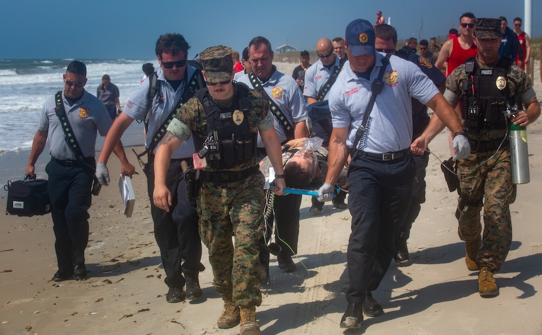 The Camp Lejeune Fire and Emergency Services Department, Provost Marshal's Office, and the Beach Detachment (DET) conducted a simulated response training exercise at Onslow Beach on Marine Corps Base Camp Lejeune, North Carolina, May 19, 2022. Each year the Beach DET conducts a training exercise to familiarize first responders, and other individuals, with the expectations of response in case of an emergency. (U.S. Marine Corps photo by Lance Cpl. Khalil Brown)