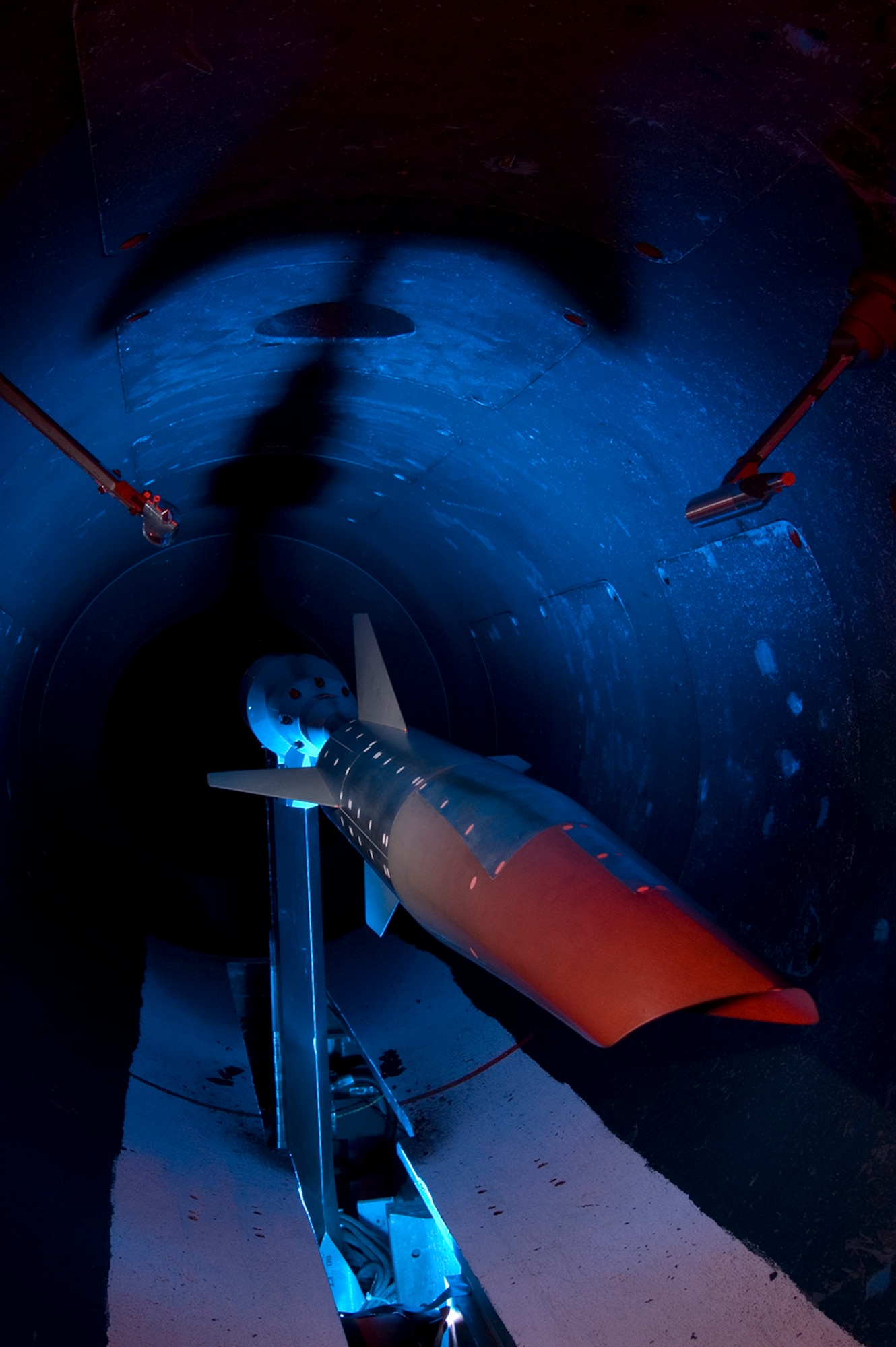 A Mach 10 Scramjet-powered vehicle configuration undergoes testing at Arnold Engineering Development Complex Hypervelocity Wind Tunnel 9 in White Oak, Maryland, in 2010. This was among the thousands of test runs that have now occurred at the facility. On April 11, 2022, the test crew at Tunnel executed the 5,000th run at Tunnel 9. (U.S. Air Force photo)