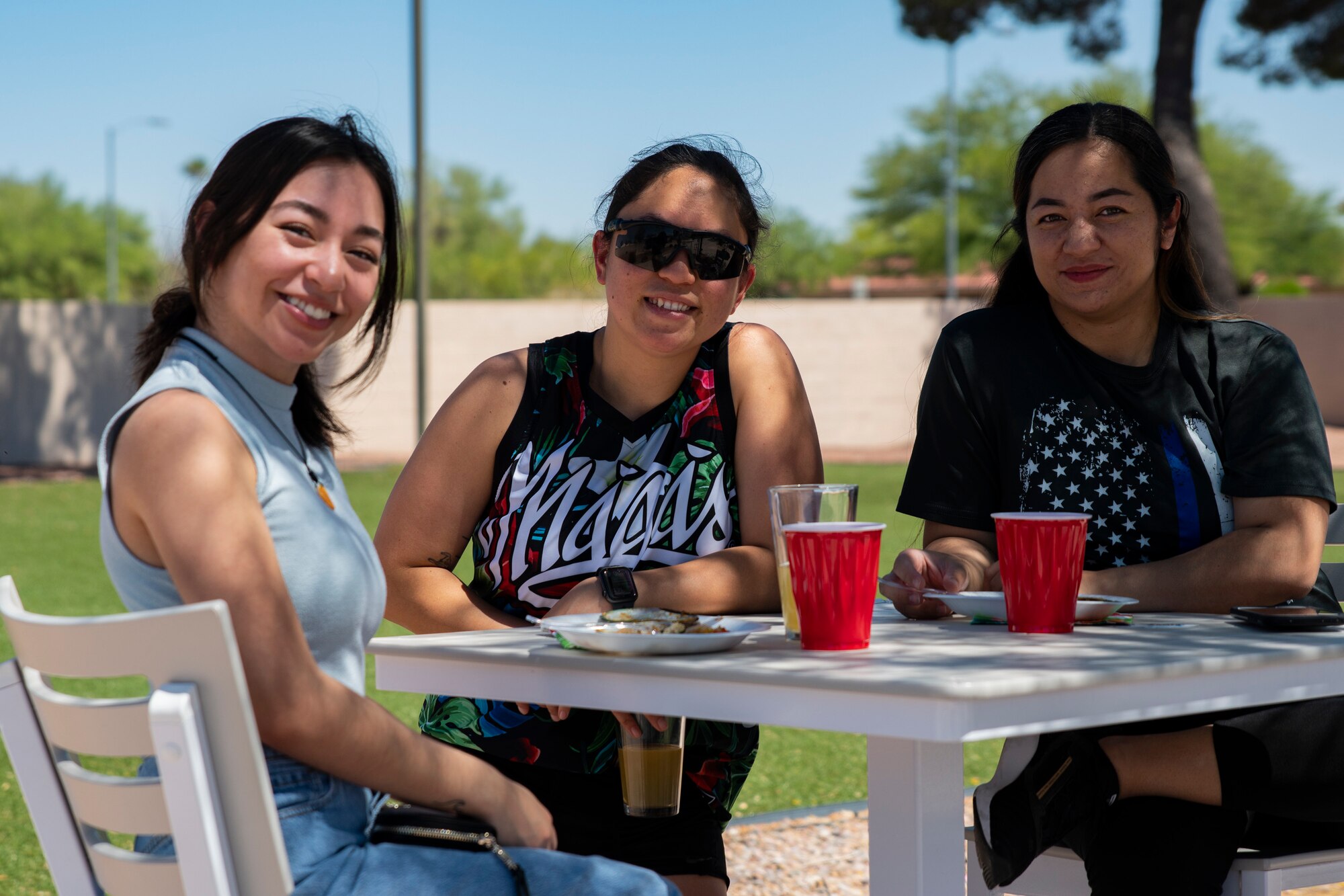 A photo of three people smiling.