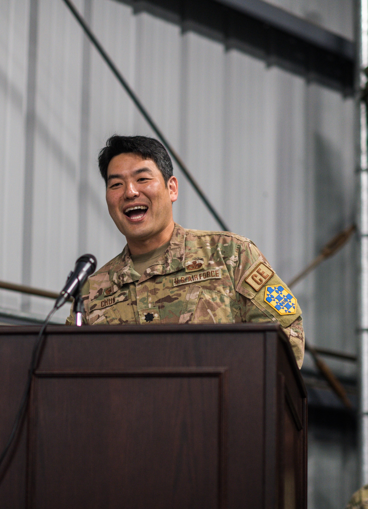 Outgoing 61st CELS commander Lt. Col. Woo Chun gives his final remarks to the audience during his change of command ceremony which was held in their warehouse on Monday.
