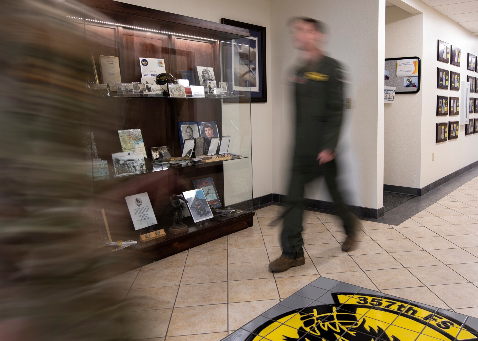 A photo of two people walking through the halls.