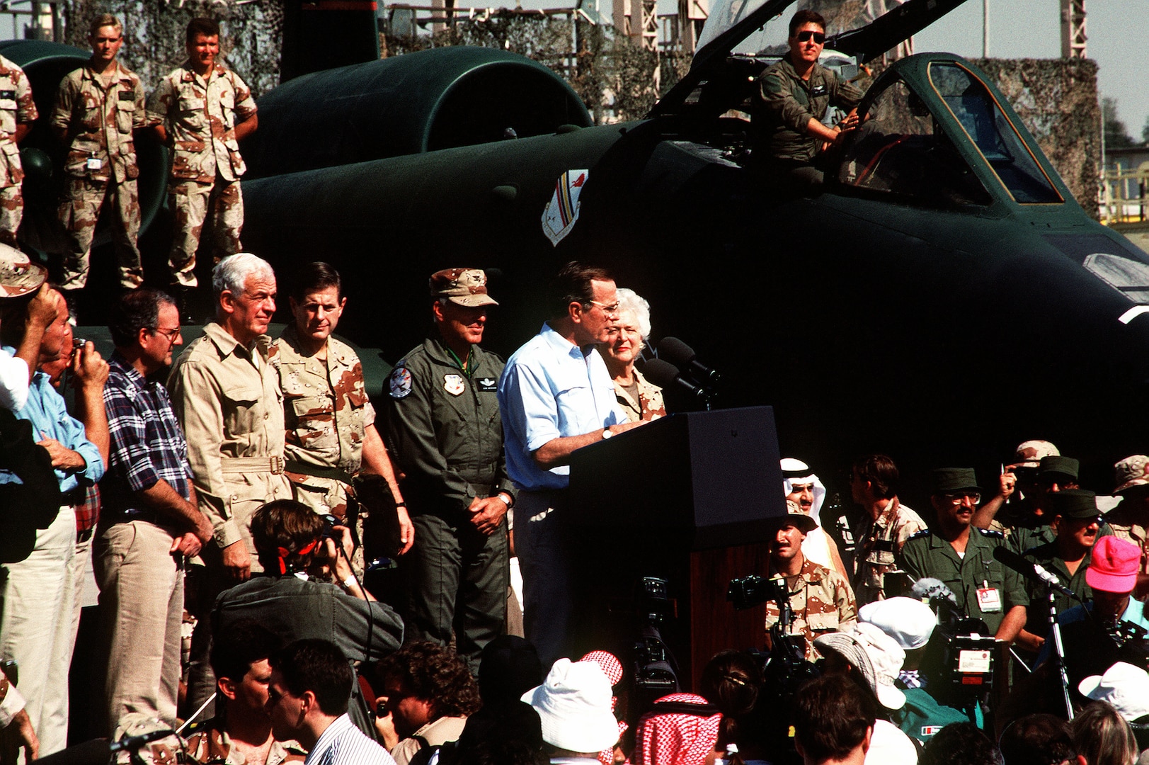 Image of people gathered together at a rally to listen to the president speak.