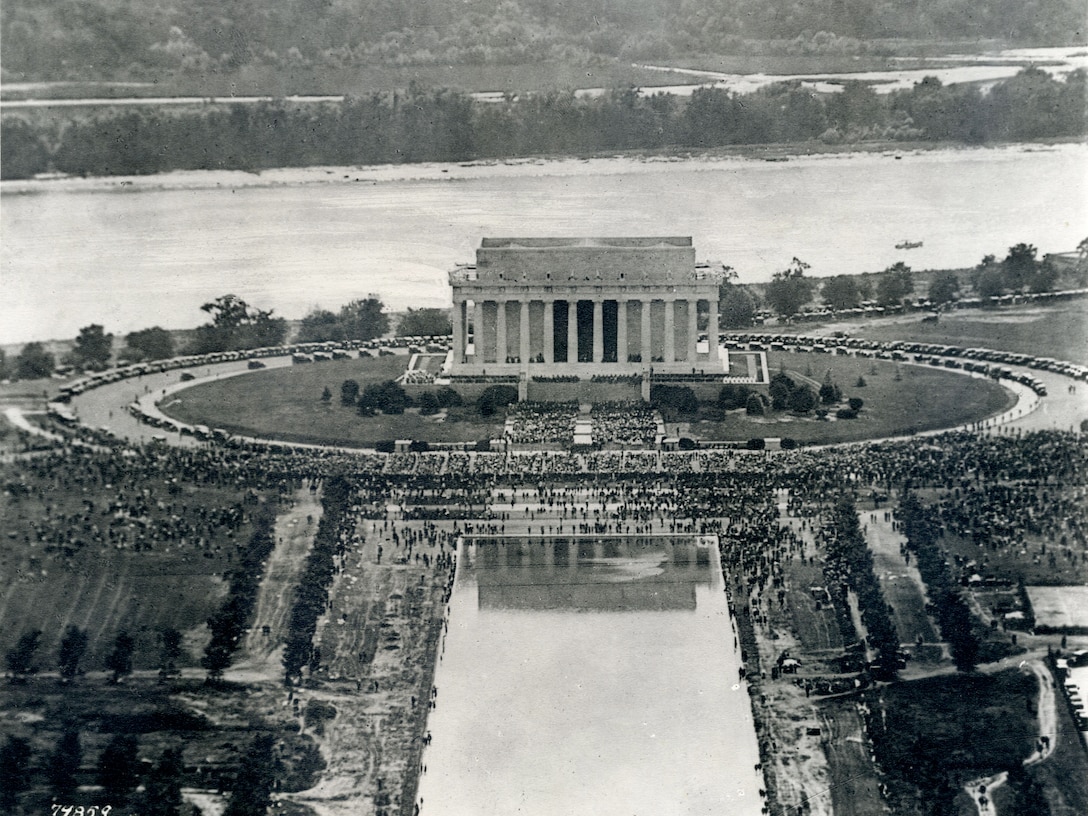 View from airplane of Lincoln Memorial, Reflecting Pool, Potomac River and the crowds attending the dedication of the Lincoln Memorial. May 30, 1922. Washington, D.C. Chief Justice and former President William Howard Taft, who had sat on the LMC, presided over the festivities.