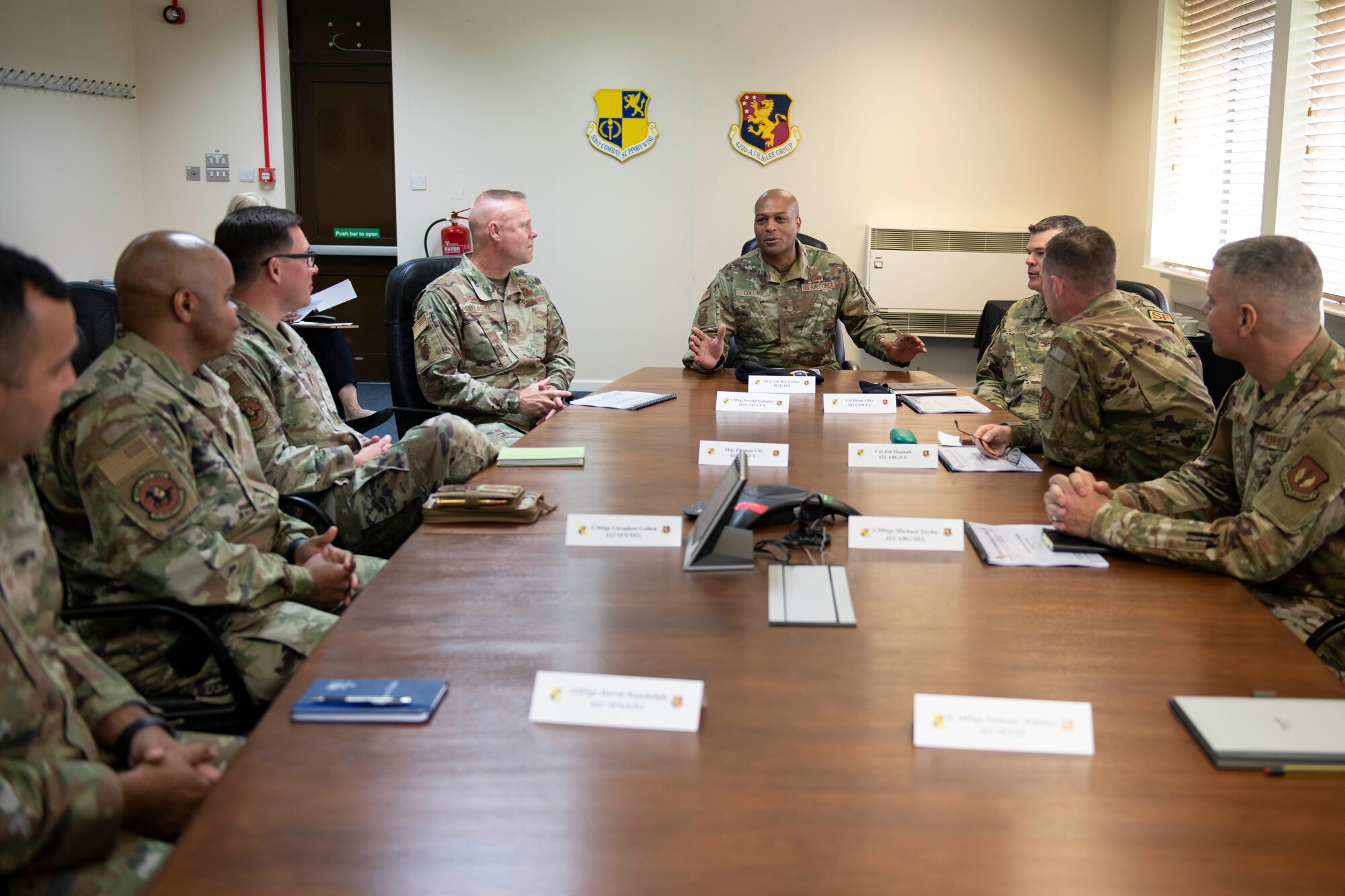 U.S. Air Force Brig. Gen. Roy W. Collins, center, Headquarters U.S. Air Force director of security forces and deputy chief of staff for logistics, engineering and force protection, speaks with 501st Combat Support Wing leaders during a visit to Royal Air Force Croughton, England, May 23, 2022. Collins and Chief Master Sgt. Donald S. Gallagher, 20th Security Forces career field manager, visited RAF Croughton to present the 2021 Air Force Best Small Security Forces Squadron to the 422nd Security Forces Squadron. (U.S. Air Force photo by Senior Airman Jennifer Zima)