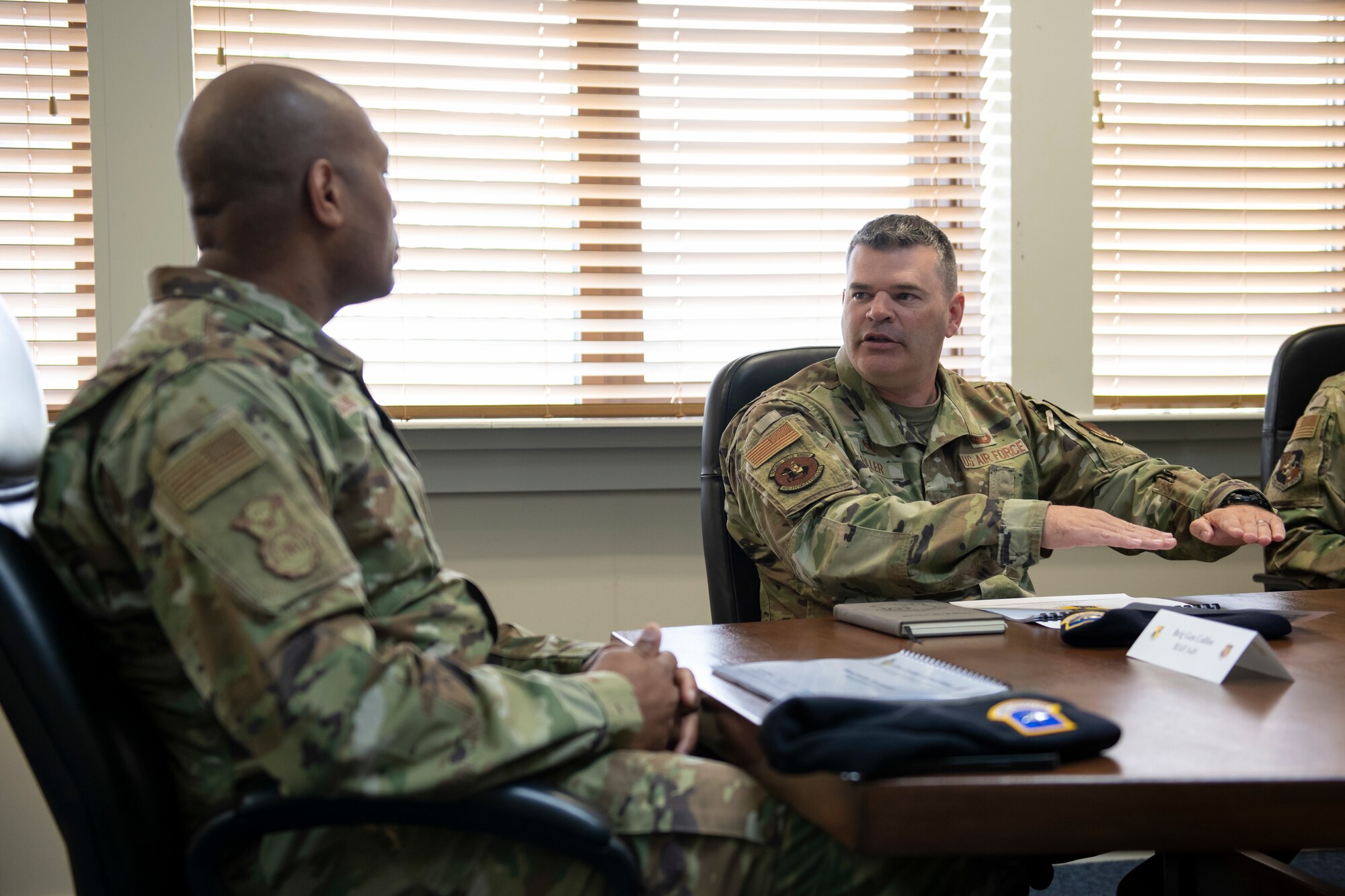 U.S. Air Force Col. Brian Filler, right, 501st Combat Support Wing commander, speaks with Brig. Gen. Roy W. Collins, left, Headquarters U.S. Air Force director of security forces and deputy chief of staff for logistics, engineering and force protection, during a visit to Royal Air Force Croughton, England, May 23, 2022. Collins and Chief Master Sgt. Donald S. Gallagher, 20th Security Forces career field manager, visited RAF Croughton to present the 2021 Air Force Best Small Security Forces Squadron to the 422nd Security Forces Squadron. (U.S. Air Force photo by Senior Airman Jennifer Zima)