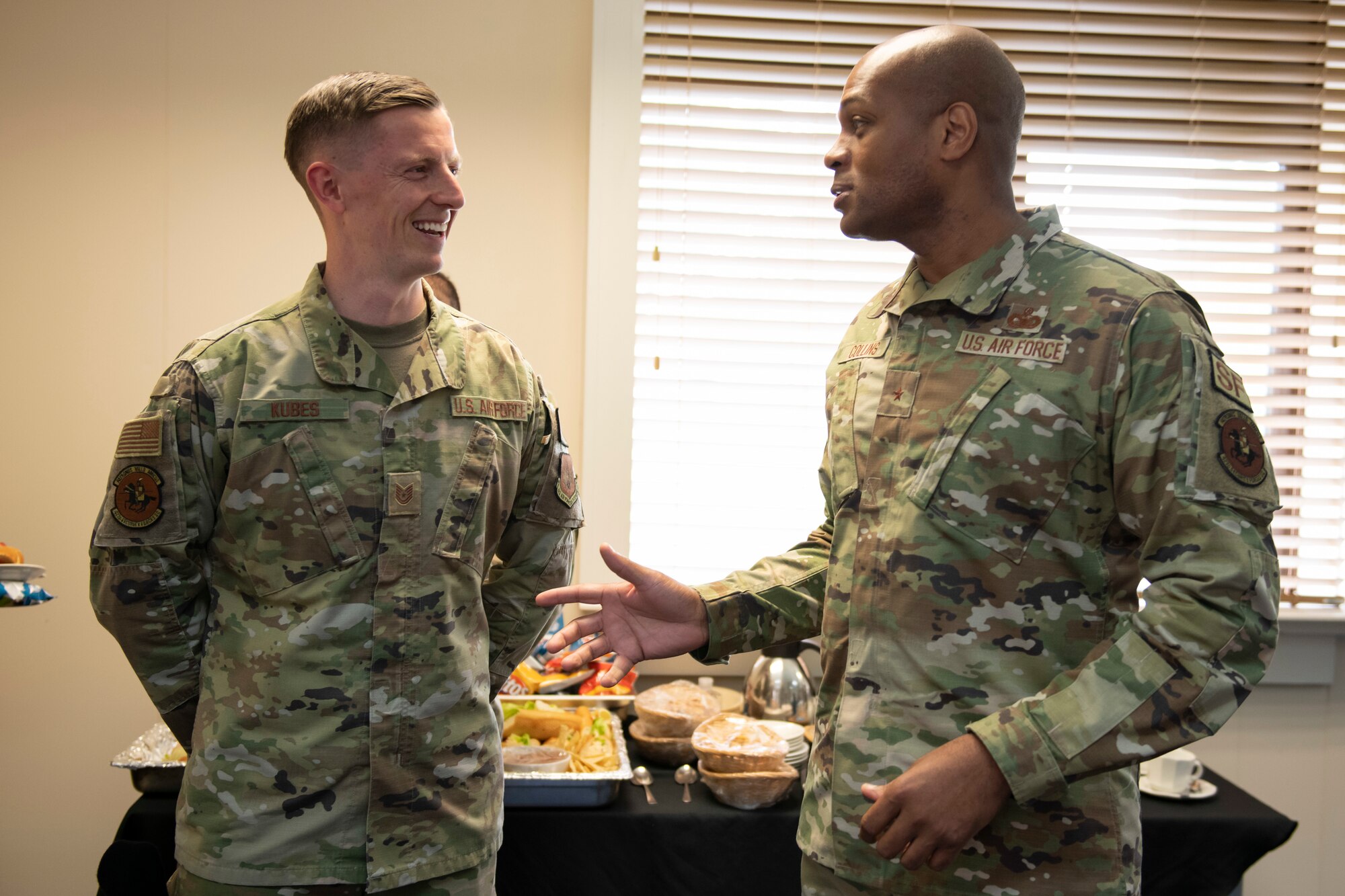 U.S. Air Force Brig. Gen. Roy W. Collins, right, Headquarters U.S. Air Force director of security forces and deputy chief of staff for logistics, engineering and force protection, recognizes Tech. Sgt. Mason Kubes, left, 422nd Security Forces Squadron noncommissioned officer in charge of plans and programs, during a visit to Royal Air Force Croughton, England, May 23, 2022. Collins and Chief Master Sgt. Donald S. Gallagher, 20th Security Forces career field manager, visited RAF Croughton to present the 2021 Air Force Best Small Security Forces Squadron to the 422nd Security Forces Squadron. (U.S. Air Force photo by Senior Airman Jennifer Zima)