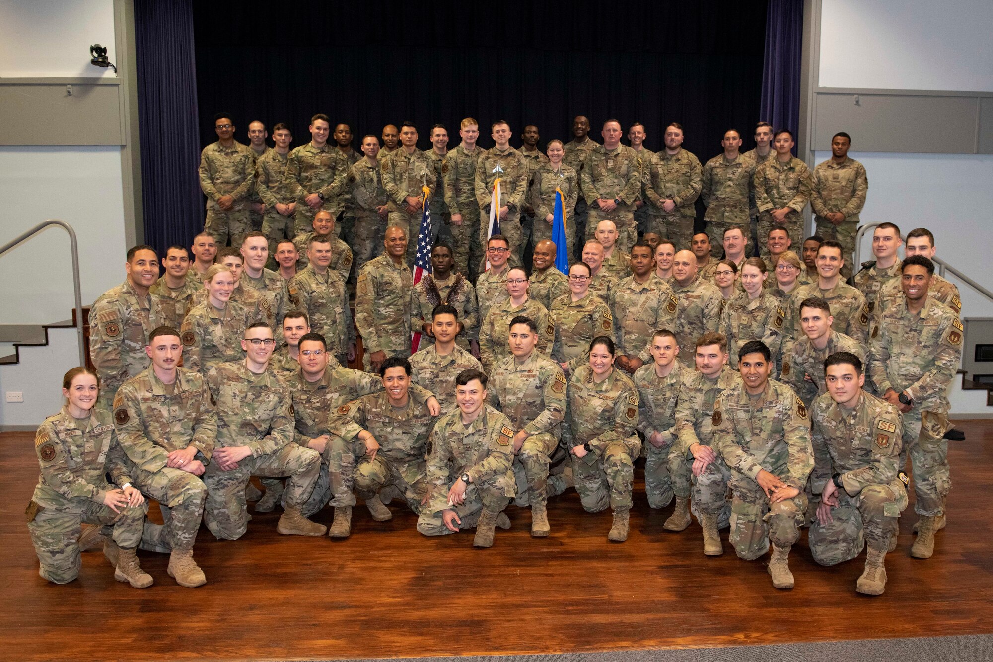 U.S. Air Force Chief Master Sgt. Donald S. Gallagher, 20th Security Forces career field manager, and Chief Master Sgt. Donald S. Gallagher, 20th Security Forces career field manager, present the 2021 Air Force Best Small Security Forces Squadron to the 422nd Security Forces Squadron Airmen during a visit to Royal Air Force Croughton, England, May 23, 2022. Gallagher and Collins visited RAF Croughton to meet and recognize the 422nd SFS Airmen. (U.S. Air Force photo by Senior Airman Jennifer Zima)