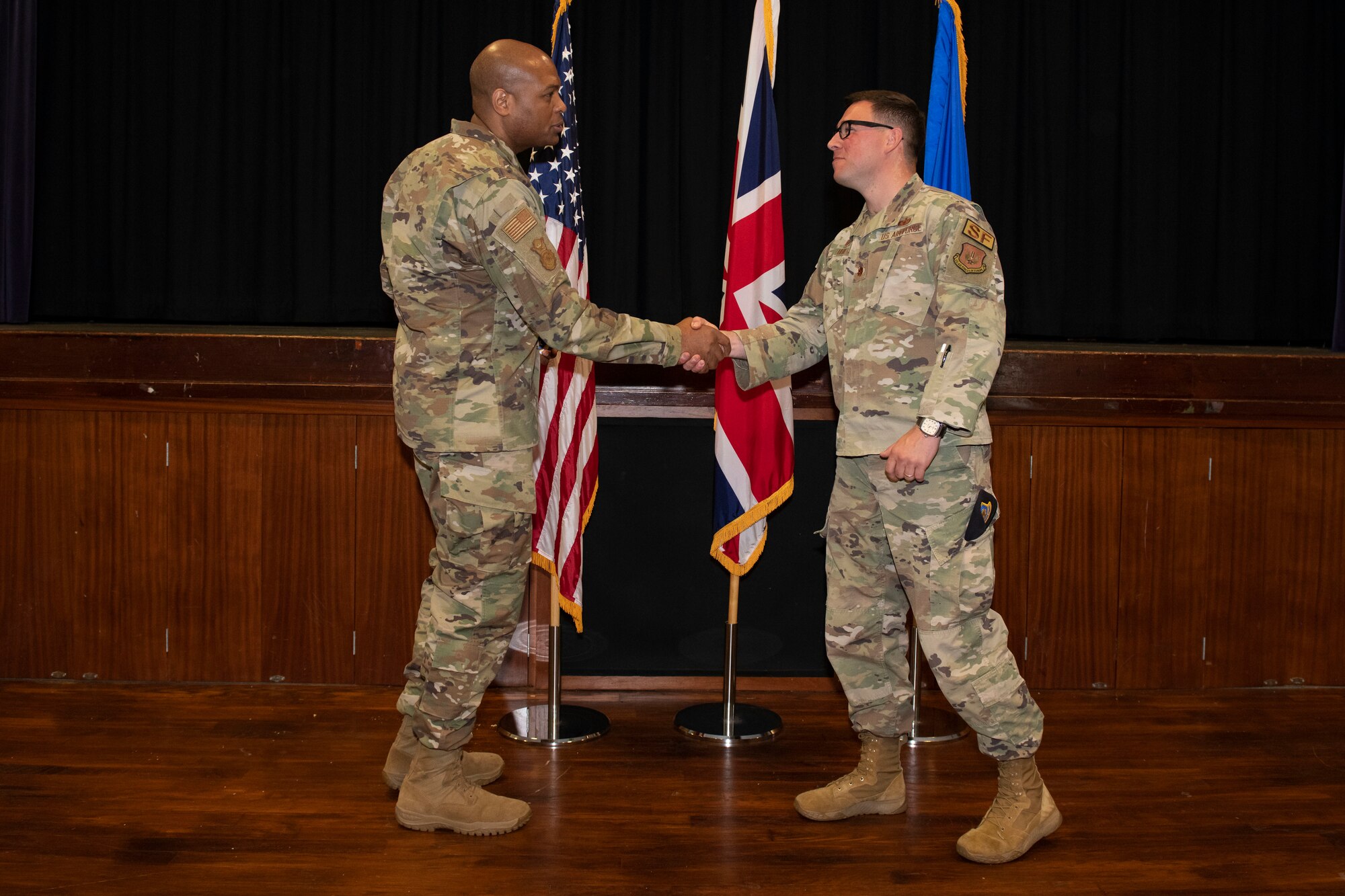 U.S. Air Force Brig. Gen. Roy W. Collins, left, Headquarters U.S. Air Force director of security forces and deputy chief of staff for logistics, engineering and force protection, recognizes Maj. Thomas Uhl, right, 422nd Security Forces Squadron commander, during a visit to Royal Air Force Croughton, England, May 23, 2022. Collins and Chief Master Sgt. Donald S. Gallagher, 20th Security Forces career field manager, visited RAF Croughton to present the 2021 Air Force Best Small Security Forces Squadron to the 422nd SFS. (U.S. Air Force photo by Senior Airman Jennifer Zima)