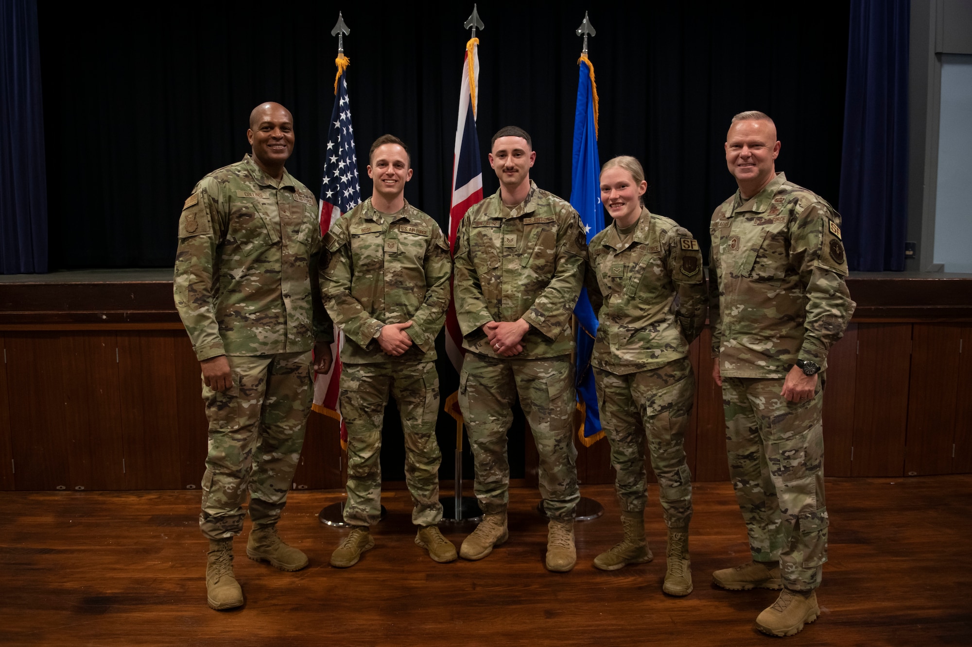 U.S. Air Force Brig. Gen. Roy W. Collins, left, Headquarters U.S. Air Force director of security forces and deputy chief of staff for logistics, engineering and force protection, and Chief Master Sgt. Donald S. Gallagher, right, 20th Security Forces career field manager, recognize 422nd Security Forces Squadron Airmen during a visit to Royal Air Force Croughton, England, May 23, 2022. Gallagher and Collins visited RAF Croughton to meet and recognize the 422nd SFS Airmen. (U.S. Air Force photo by Senior Airman Jennifer Zima)
