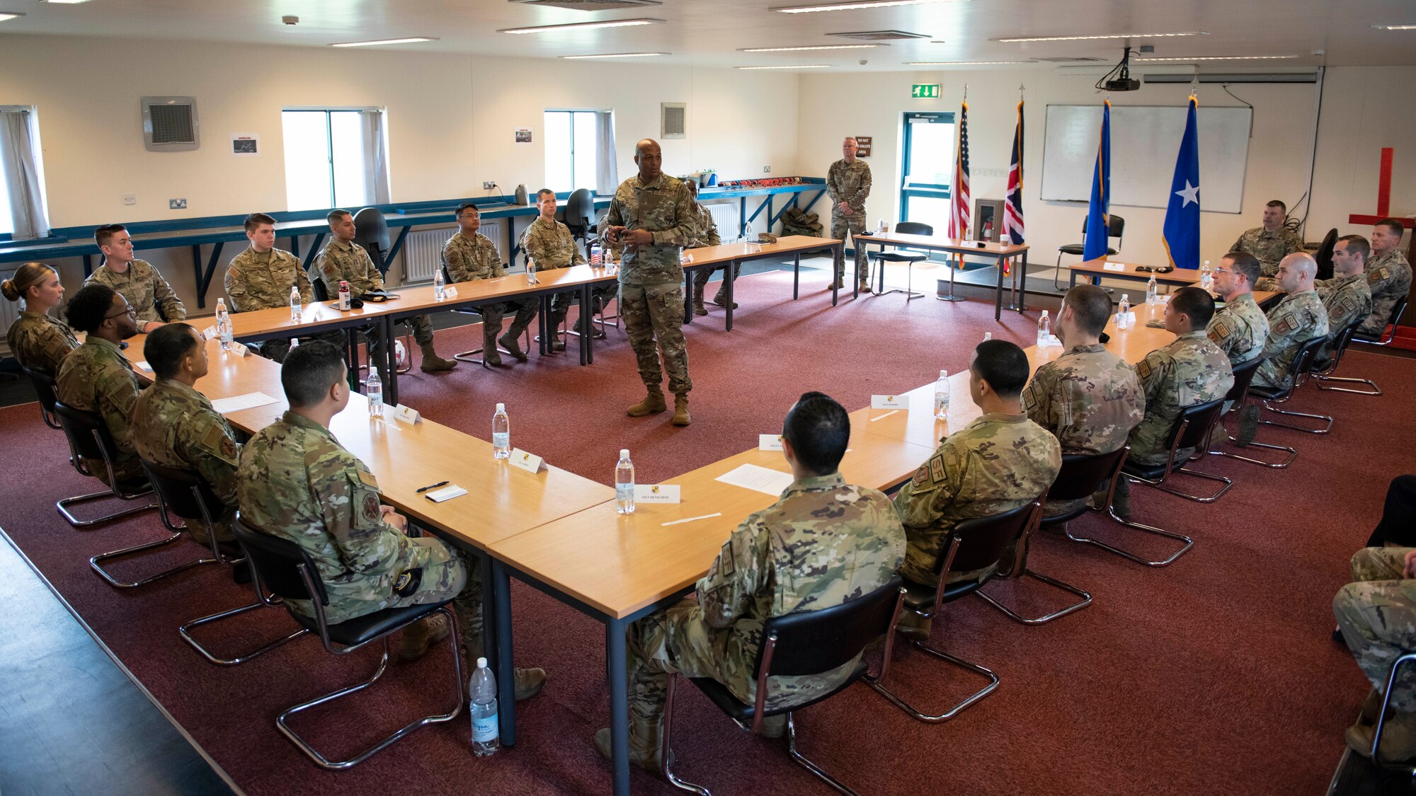U.S. Air Force Brig. Gen. Roy W. Collins, center, Headquarters U.S. Air Force director of security forces and deputy chief of staff for logistics, engineering and force protection, speaks with 423rd Security Forces Squadron defenders during a visit to Royal Air Force Molesworth, England, May 24, 2022. Collins and Chief Master Sgt. Donald S. Gallagher, 20th Security Forces career field manager, visited RAF Molesworth to meet and recognize the 423rd SFS Airmen. (U.S. Air Force photo by Senior Airman Jennifer Zima)