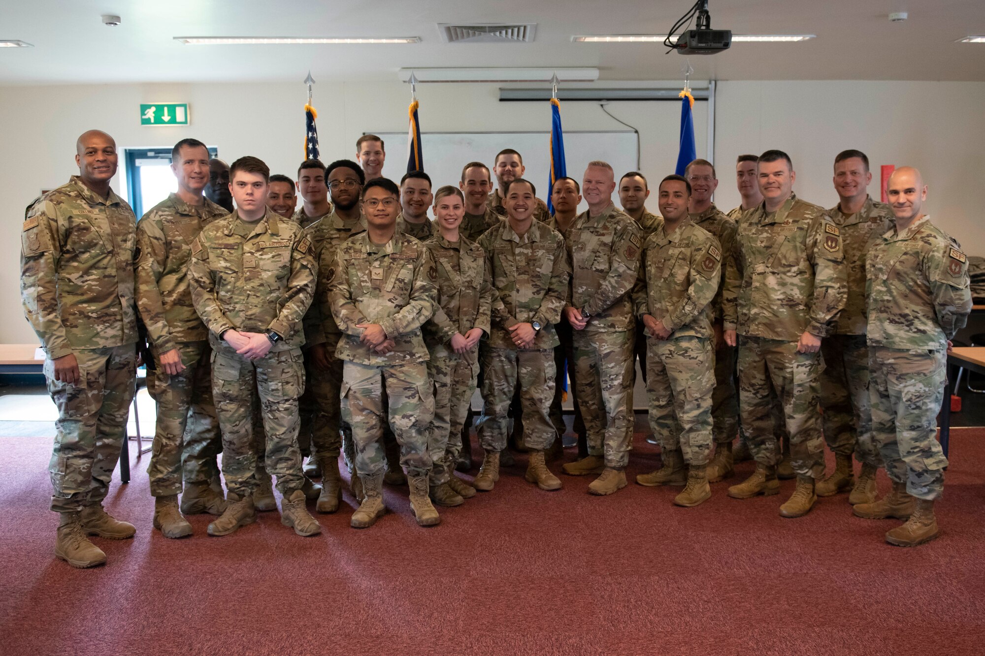 U.S. Air Force Brig. Gen. Roy W. Collins, left, Headquarters U.S. Air Force director of security forces and deputy chief of staff for logistics, engineering and force protection, and Chief Master Sgt. Donald S. Gallagher, 20th Security Forces career field manager, recognize 423rd Security Forces Squadron Airmen during a visit to Royal Air Force Molesworth, England, May 24, 2022. Collins and Gallagher visited RAF Molesworth to meet and recognize the 423rd SFS Airmen. (U.S. Air Force photo by Senior Airman Jennifer Zima)