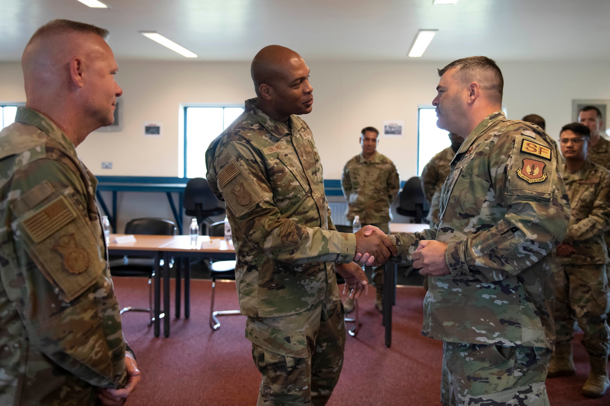 U.S. Air Force Col. Brian Filler, right, 501st Combat Support Wing commander, thanks Brig. Gen. Roy W. Collins, center, Headquarters U.S. Air Force director of security forces and deputy chief of staff for logistics, engineering and force protection, for visiting the 501st CSW at Royal Air Force Molesworth, England, May 24, 2022. Collins and Chief Master Sgt. Donald S. Gallagher, 20th Security Forces career field manager, visited RAF Molesworth to meet and recognize the 423rd Security Forces Squadron. (U.S. Air Force photo by Senior Airman Jennifer Zima)