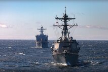 The Arleigh Burke-class guided-missile destroyer USS Gravely (DDG 107) sails in formation behind the wasp-class amphibious assault ship USS Kearsarge (LHD 3) during a maneuvering exercise with the Finnish and Swedish navies in the Baltic Sea, May 17, 2022.