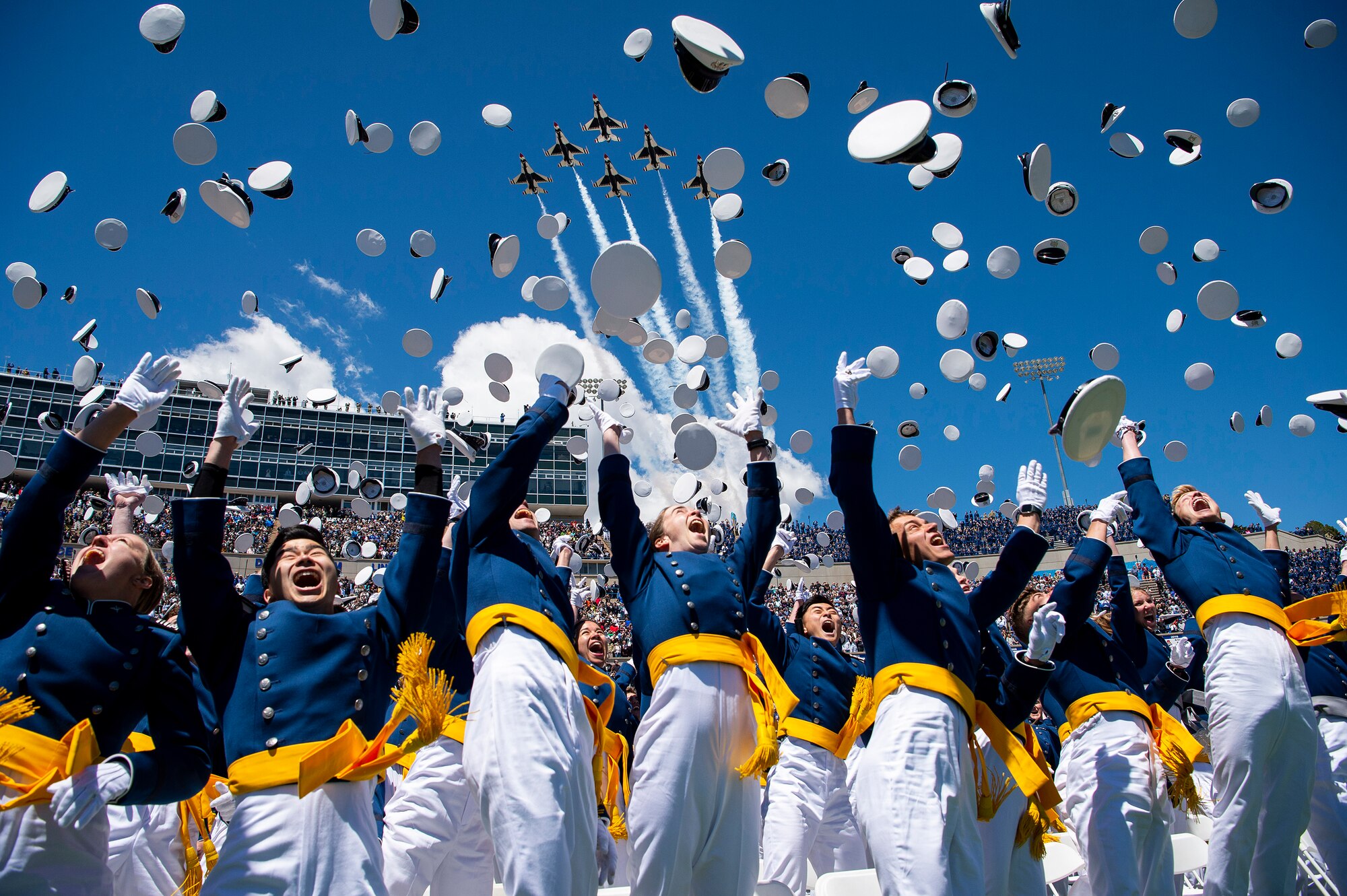 The U.S. Air Force Academy Class of 2022 graduates toss their hats into the sky