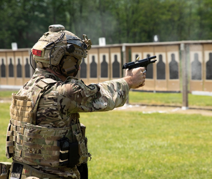 An Airman from the Pennsylvania National Guard's M9 pistol ejects an empty brass before loading the next round during the pistol portion of the Governor's Twenty competition on May 21, 2022. Airmen and Soldiers were challenged with pistol and rifle accuracy challenges.