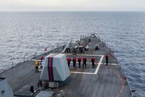 Sailors, aboard Arleigh-Burke class guided-missile destroyer USS Jason Dunham (DDG 109), man a phone-and-distance line on the fo’c’sle, in the Ionian Sea, May 12, 2022.