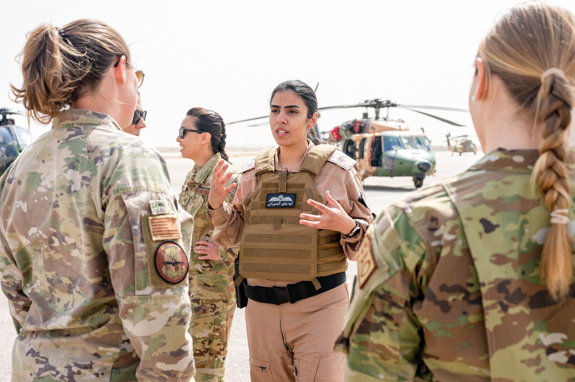Lieutenant Aya Al-Sourani, Royal Jordanian Air Force Unified Helicopter Command Squadron 8 UH-60 Black Hawk pilot, talks with U.S. Air Force visitors during a visit at King Abdullah II Air Base, Jordan on March 30, 2022. The RJAF UHC hosted a combat search and rescue exercise demonstration followed by static aircraft tours and a group lunch. The engagement is part of an ongoing partnership between the two countries focused on empowering women in aviation as a way to cultivate and strengthen relationships. (U.S. Air Force photo by Master Sgt. Kelly Goonan)